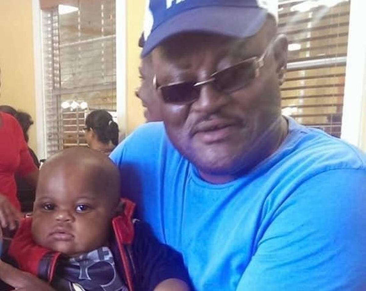 William Surles holds his great grandson, Caden, in this undated file photo. Surles was found dead by detention officers in the Harnett County jail on Dec. 19, 2022.