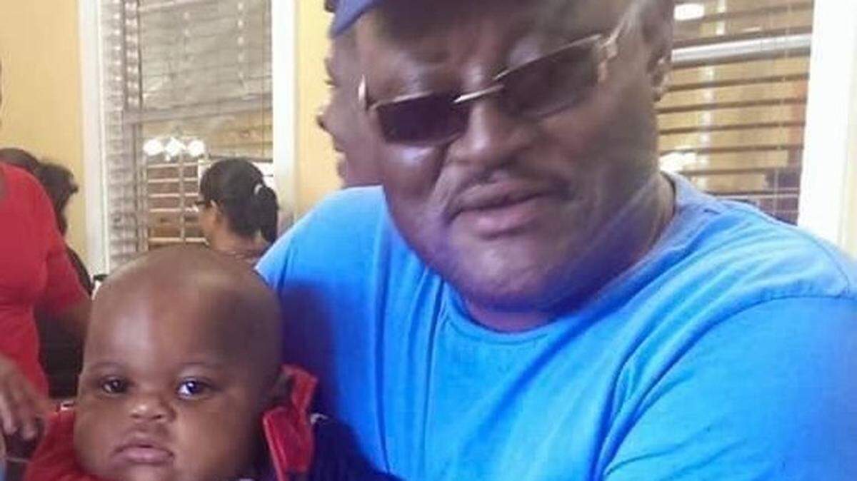 William Surles holds his great grandson, Caden, in this undated file photo. Surles was found dead by detention officers in the Harnett County jail on Dec. 19, 2022.