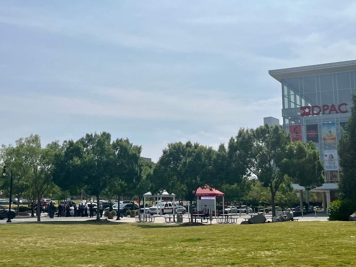 Several dozen police officers stand next to the Durham Performing Arts Center as authorities investigate a bomb threat made to the Durham County Courthouse on Friday morning.
