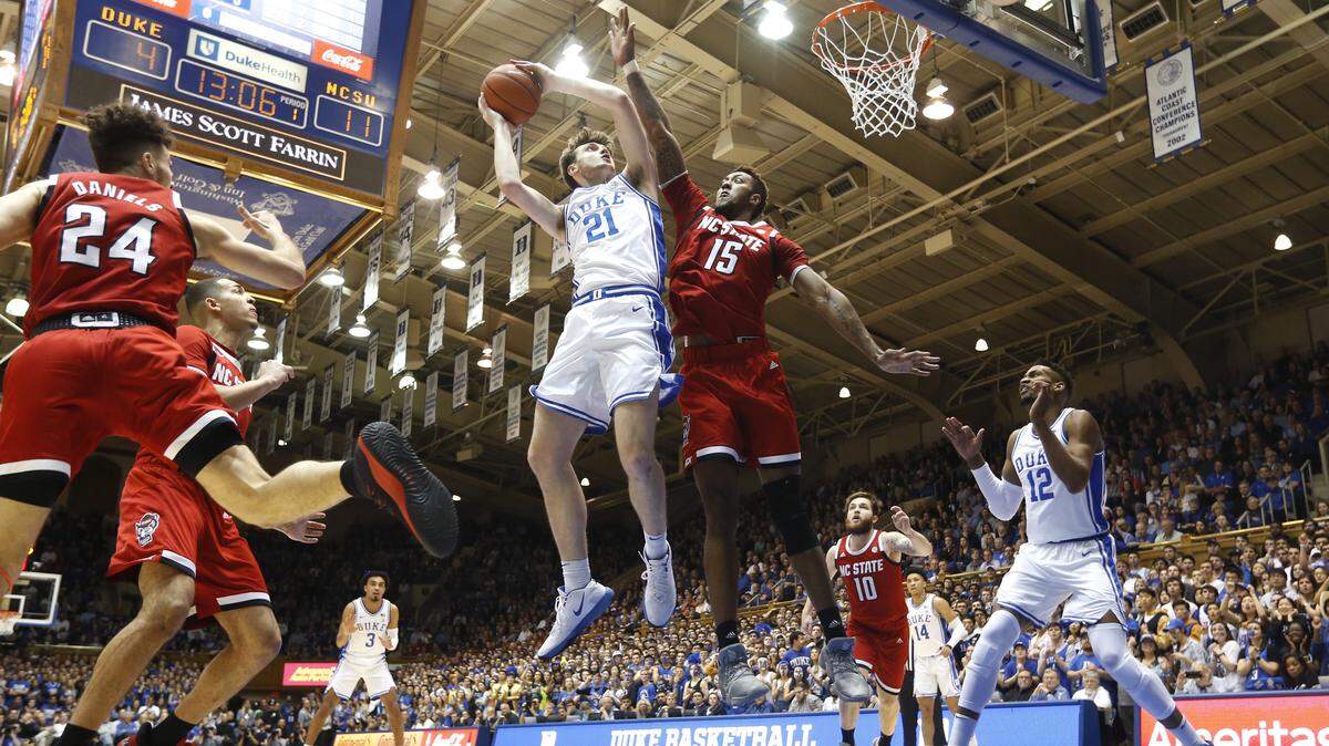 Duke’s Matthew Hurt (21) shoots as N.C. State’s Manny Bates (15) defends during the Duke Blue Devils’ 88-69 victory over the N.C. State Wolfpack at Cameron Indoor Stadium in Durham, N.C., Monday, March 2, 2020.