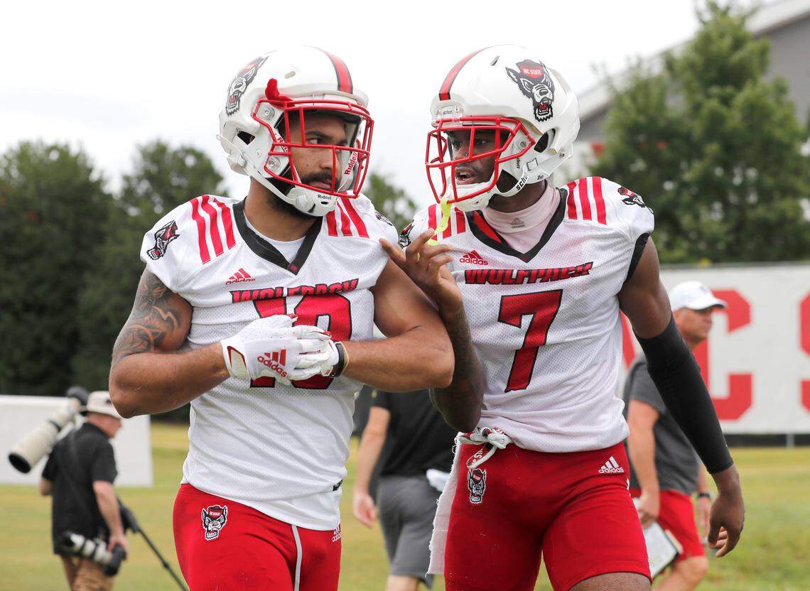 N.C. State cornerback Chris Ingram (7), right, talks with Tanner Ingle (10) during the Wolfpack’s first practice of fall camp in Raleigh, N.C., Wednesday, August 4, 2021.