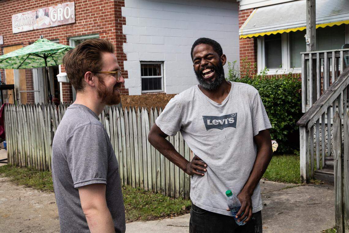 News & Observer reporter Andrew Carter, left, interviews Robert Simmons Jr. at his home in New Bern Tuesday, Sept. 18, 2018. A photograph Carter made of Robert Simmons Jr. and his kitten ‘Survivor’, in a flooded New Bern, NC, neighborhood, went viral during Hurricane Florence.