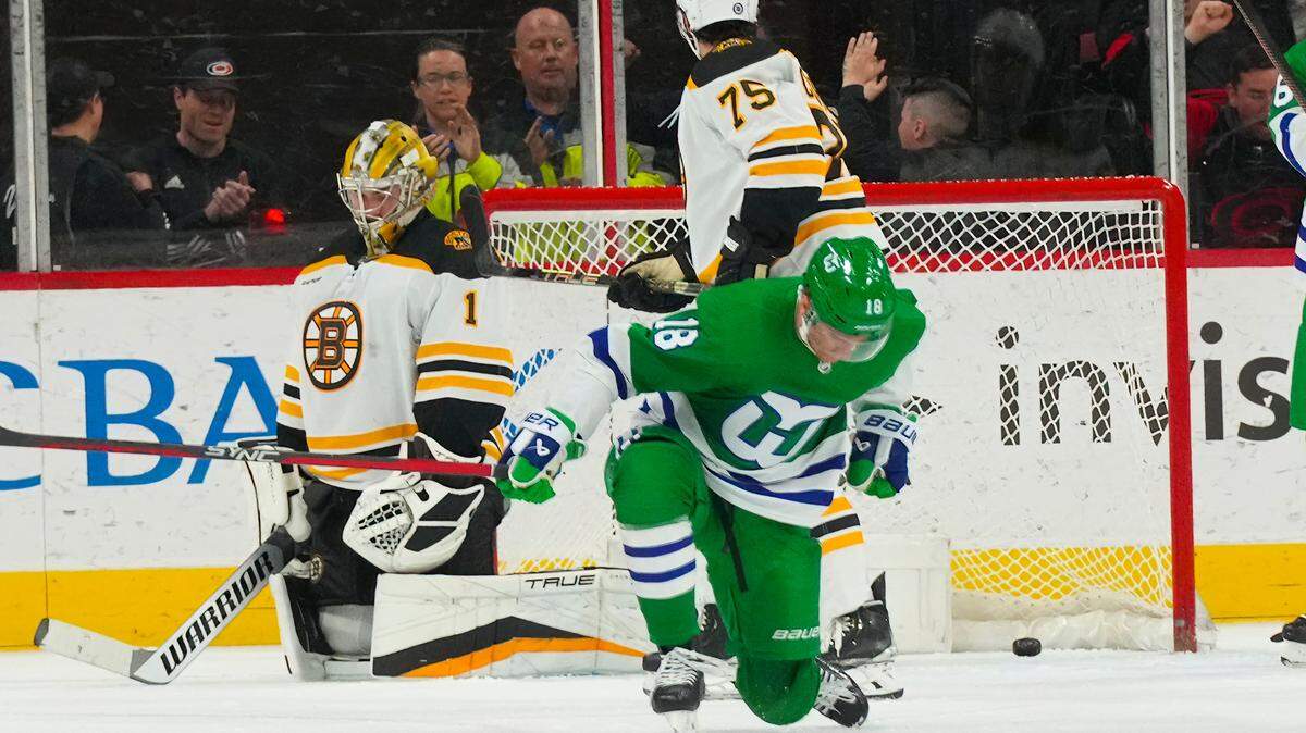 Carolina Hurricanes center Jack Drury (18) scores a goal past Boston Bruins goaltender Jeremy Swayman (1) during the second period at PNC Arena.