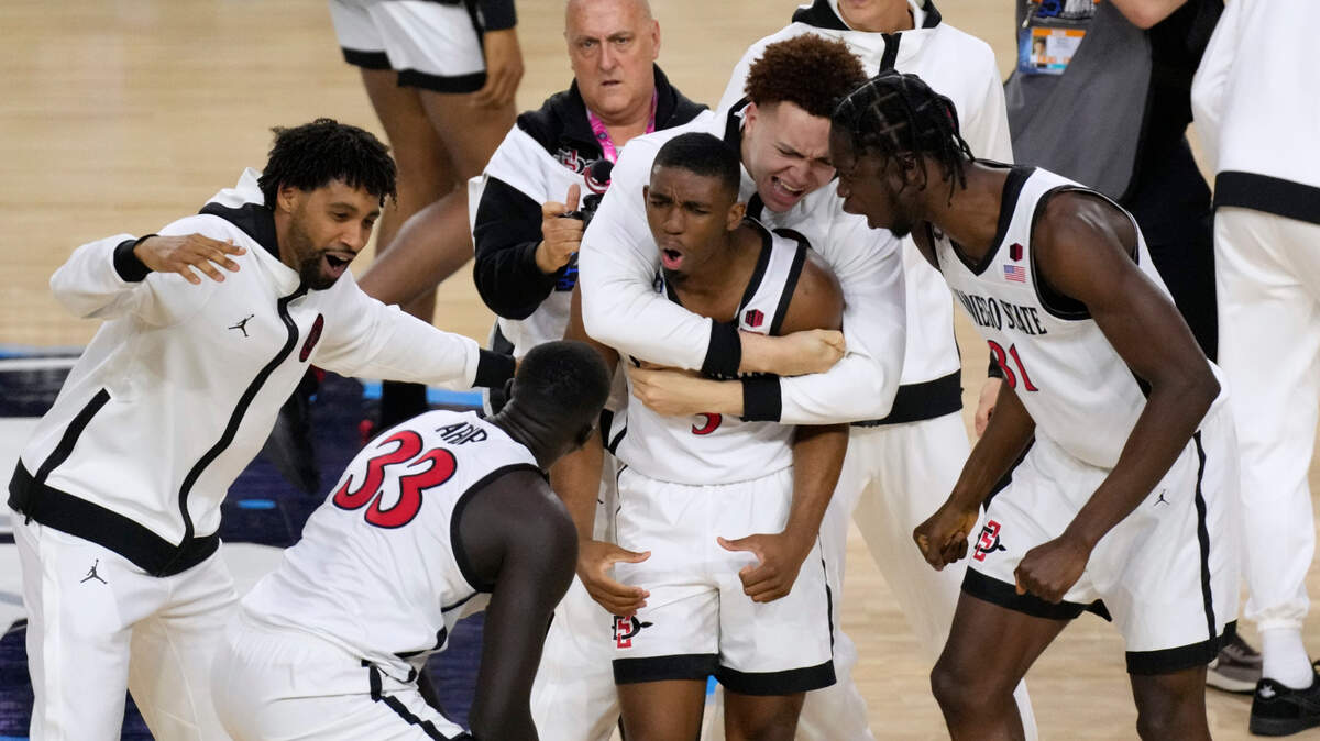 San Diego State guard Lamont Butler, center, celebrates with teammates after he hit the winning basket against Florida Atlantic during the second half of a Final Four college basketball game in the NCAA Tournament on Saturday, April 1, 2023, in Houston. (AP Photo/Godofredo A. Vasquez)