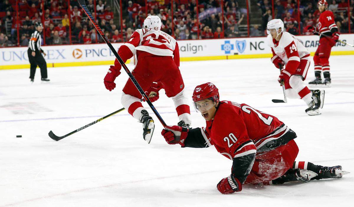 Carolina Hurricanes’ Sebastian Aho (20) looks toward an official after being tripped by Detroit Red Wings’ Danny DeKeyser (65) during overtime in an NHL hockey game Saturday, Nov. 10, 2018, in Raleigh, N.C. 