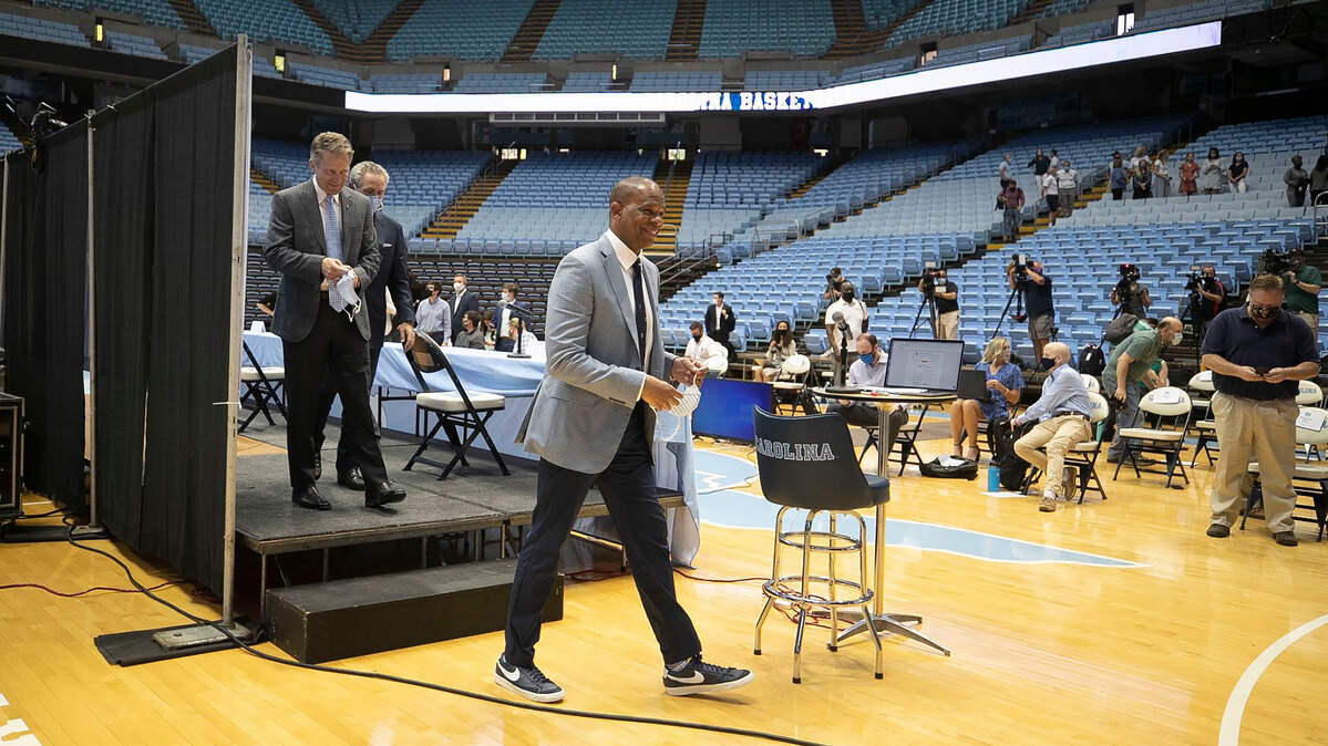 Hubert Davis steps the dais following his introduction at the new menís basketball coach at the University of North Carolina on Tuesday, April 6, 2021 at the Smith Center in Chapel Hill, N.C. Davis a former North Carolina player and an assistant coach for Roy Williams, replaces Williams who retired last week following 18 years as head coach.