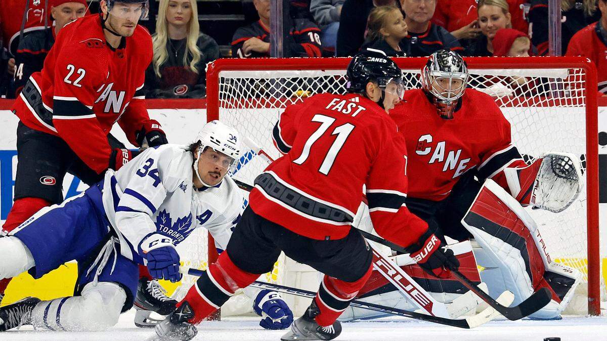 Carolina Hurricanes’ Jesper Fast (71) takes the puck from in front of goaltender Frederik Andersen (31) with Toronto Maple Leafs’ Auston Matthews (34) and Hurricanes’ Brett Pesce (22) nearby during the second period of an NHL hockey game in Raleigh, N.C., Sunday, Nov. 6, 2022. (AP Photo/Karl B DeBlaker)