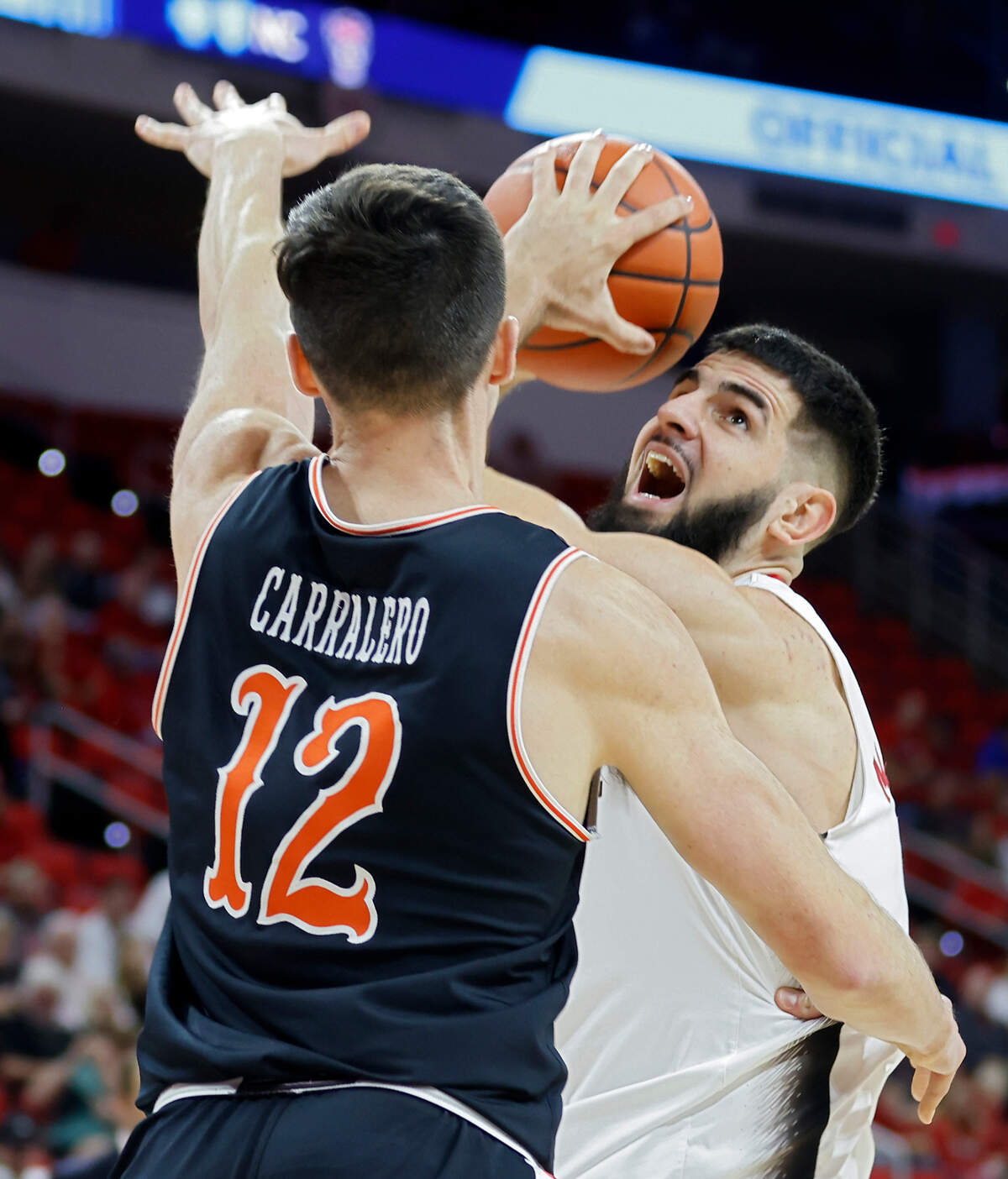 North Carolina State Wolfpack forward Dusan Mahorcic looks to shoot over Campbell Fighting Camels forward Jesus Carralero during the first half of a men’s basketball game at PNC Arena in Raleigh, N.C. on Friday, Nov. 11, 2022.