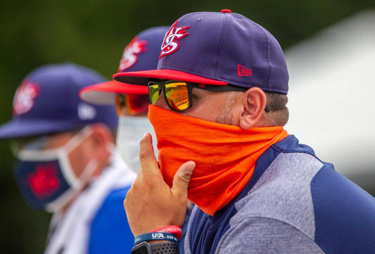 Baseball scouts including Jim Maciejewski, foreground, wear face covering during the 17U National Team Championships at the USA Baseball National Training Complex in Cary Thursday, July 30, 2020.