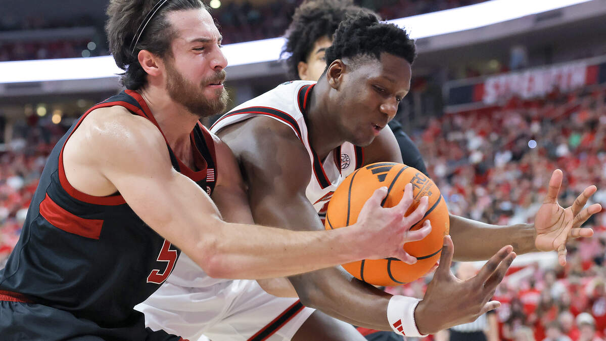 Stanford's Benny Gealer and N.C. State's Musa Sagnia battle for possession during the Cardinal’s 85-84 win on March 7, at Lenovo Center in Raleigh.