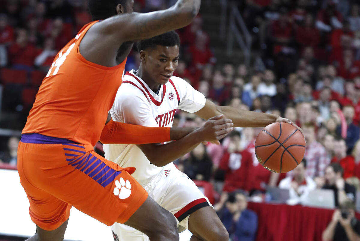 N.C. State’s Markell Johnson (11) drives around Clemson’s Elijah Thomas (14) during the first half of N.C. State’s game against Clemson at PNC Arena in Raleigh, N.C., Saturday, January 26, 2019.