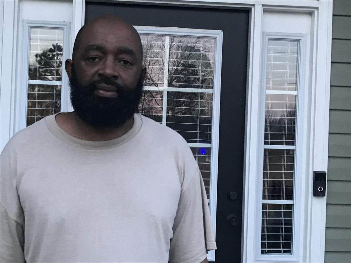 Eric Bostic stands outside his new home on Gray’s Creek Church Road. Bostic learned recently that his well is contaminated with PFAS.