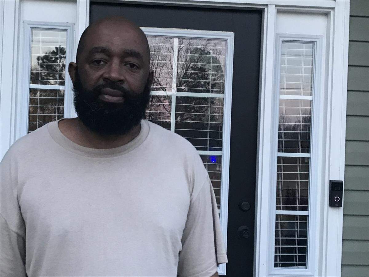 Eric Bostic stands outside his new home on Gray’s Creek Church Road. Bostic learned recently that his well is contaminated with PFAS.