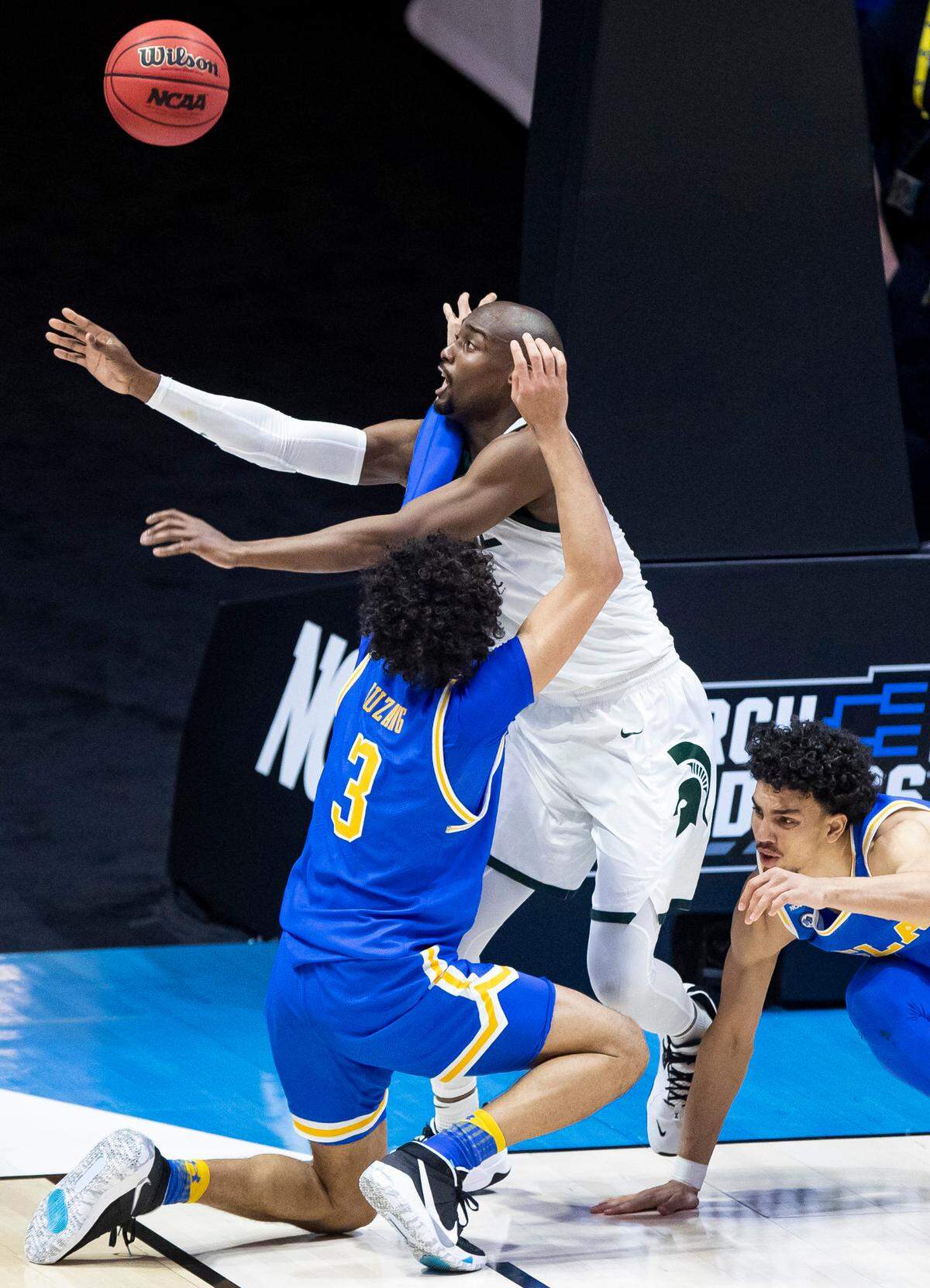 Michigan State’s Joshua Langford, second from left, competes for a rebound with UCLA’s Johnny Juzang (3) and Jules Bernard during the second half of a First Four game in the NCAA men’s college basketball tournament, early Friday, March 19, 2021, at Mackey Arena in West Lafayette, Ind. UCLA won 86-80. (AP Photo/Robert Franklin)