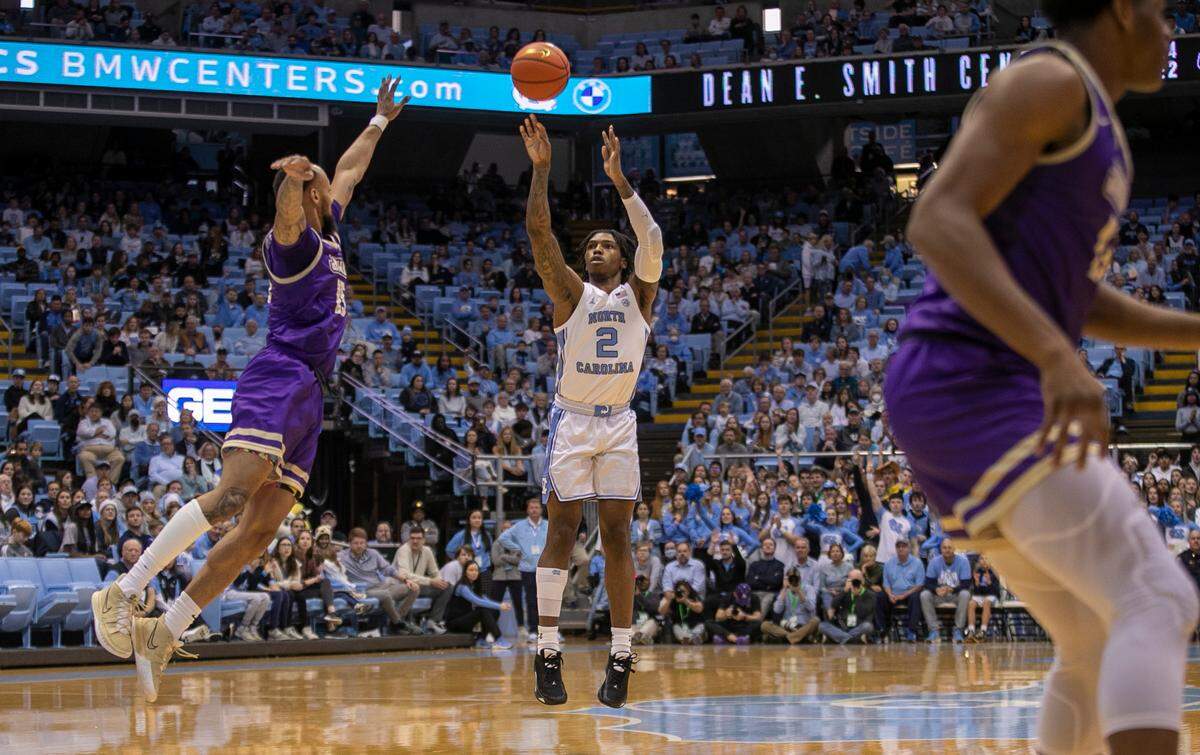 North Carolina’s Caleb Love (2) puts up a shot against James Madison’s Takal Molson (15) in the first half on Sunday, November 20, 2022 at the Smith Center in Chapel Hill, N.C.