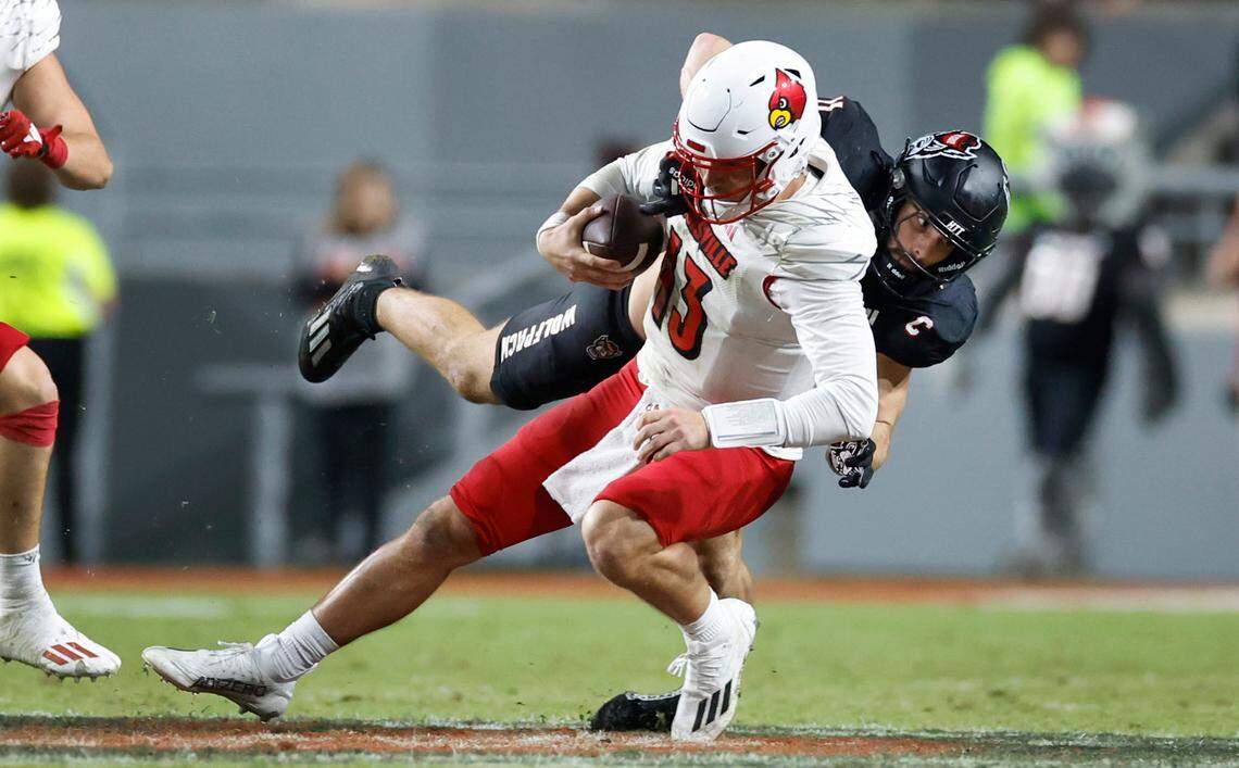N.C. State linebacker Payton Wilson (11) tackles Louisville quarterback Jack Plummer (13) during the second half of Louisville’s 13-10 victory over N.C. State at Carter-Finley Stadium in Raleigh, N.C., Friday, Sept. 29, 2023.