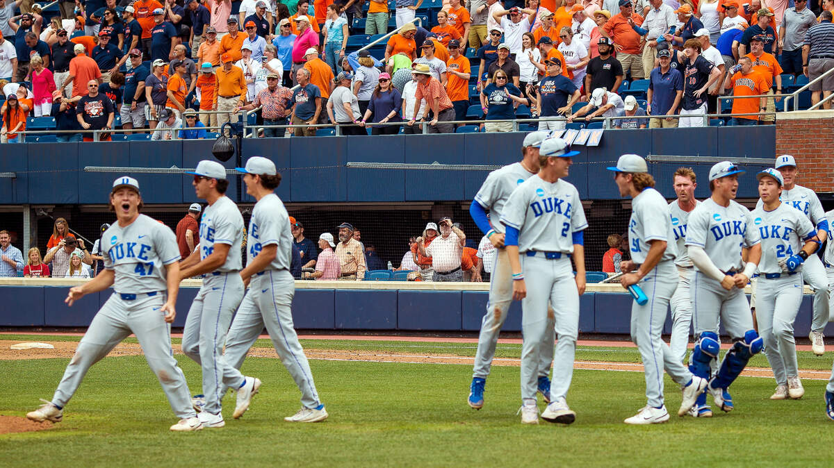 Duke players celebrate after defeating Virginia in an NCAA college baseball super regional game, Friday, June 9, 2023 in Charlottesville.