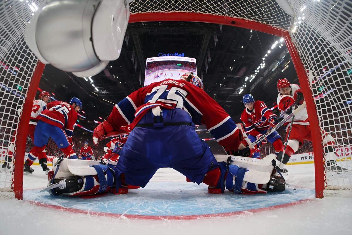 Jakub Dobes #75 and Lane Hutson #48 of the Montreal Canadiens defend the net against against Logan Stankoven #22 of the Carolina Hurricanes during the second period in Game Four of the Eastern Conference Final of the 2026 Stanley Cup Playoffs at Bell Centre on May 27, 2026 in Montreal, Quebec, Canada. 