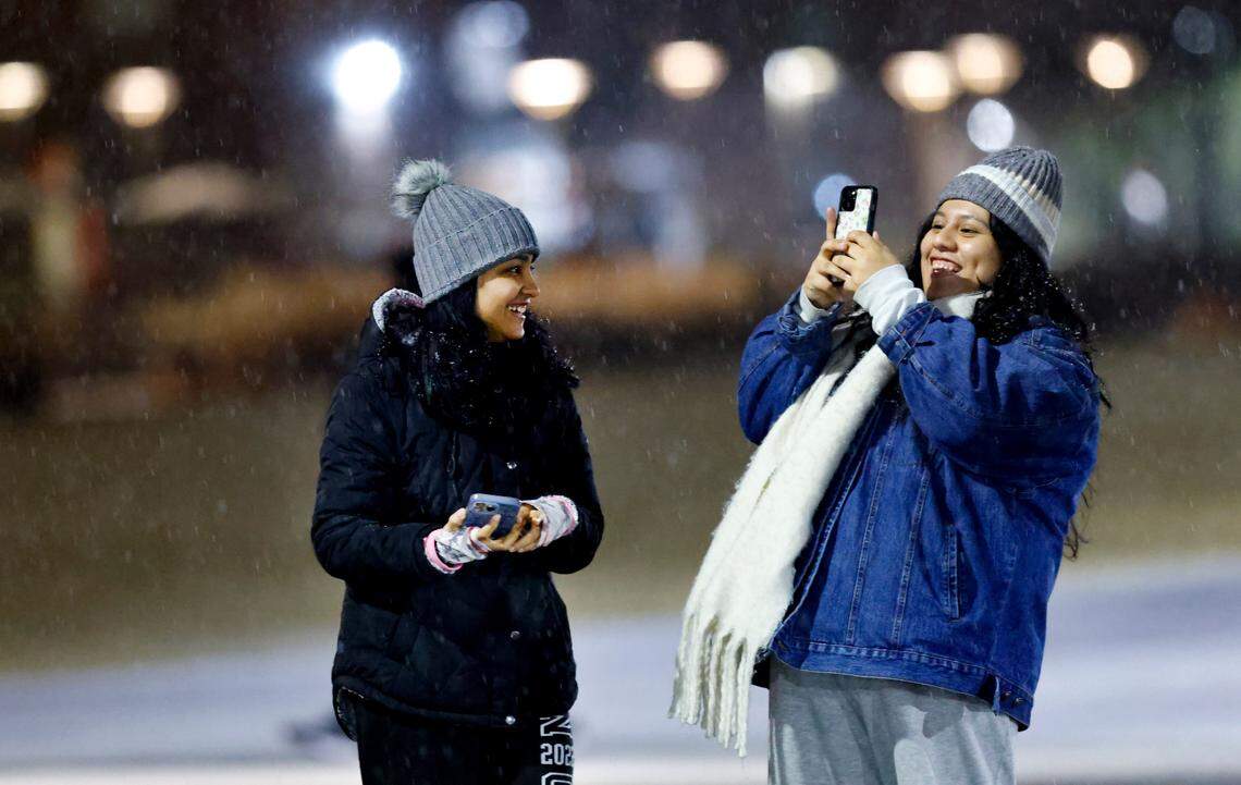 Sandhya Purohit, a N.C. State senior and Ashley Garcia, a N.C. State junior, enjoy the falling snow while on campus in Raleigh, N.C., Friday evening, Jan. 10, 2025.