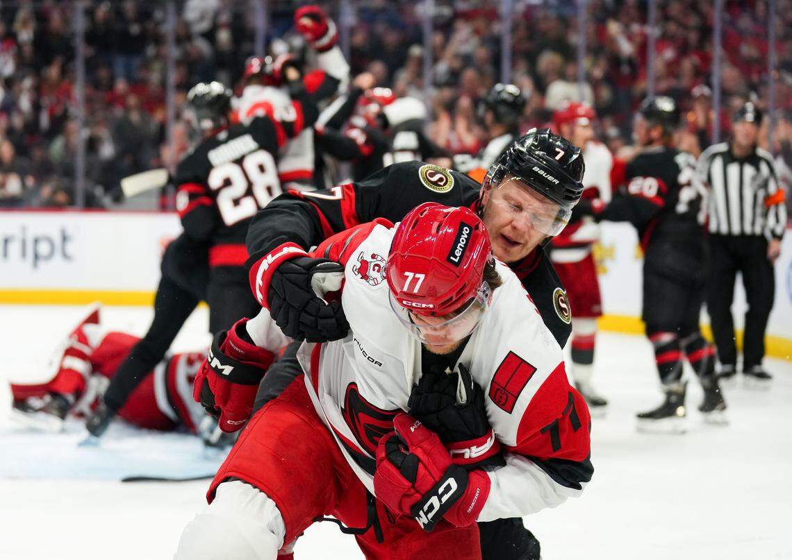 Brady Tkachuk (7) of the Ottawa Senators pushes and shoves with Mark Jankowski of the Carolina Hurricanes during the second period of Game 4 of their first-roundStanley Cup Playoff series at Canadian Tire Centre on April 25, 2026 in Ottawa, Canada.