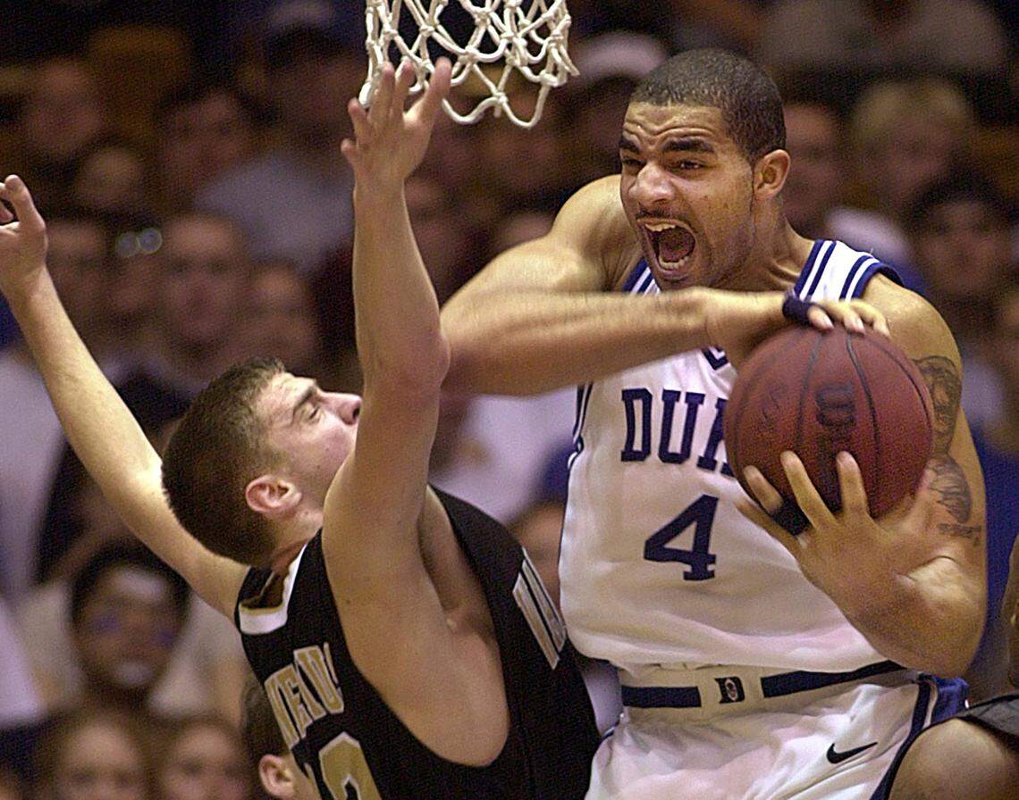 Duke’s Carlos Boozer pulls a rebound from Wake Forest’s Vytas Danelius during a game in 2002.