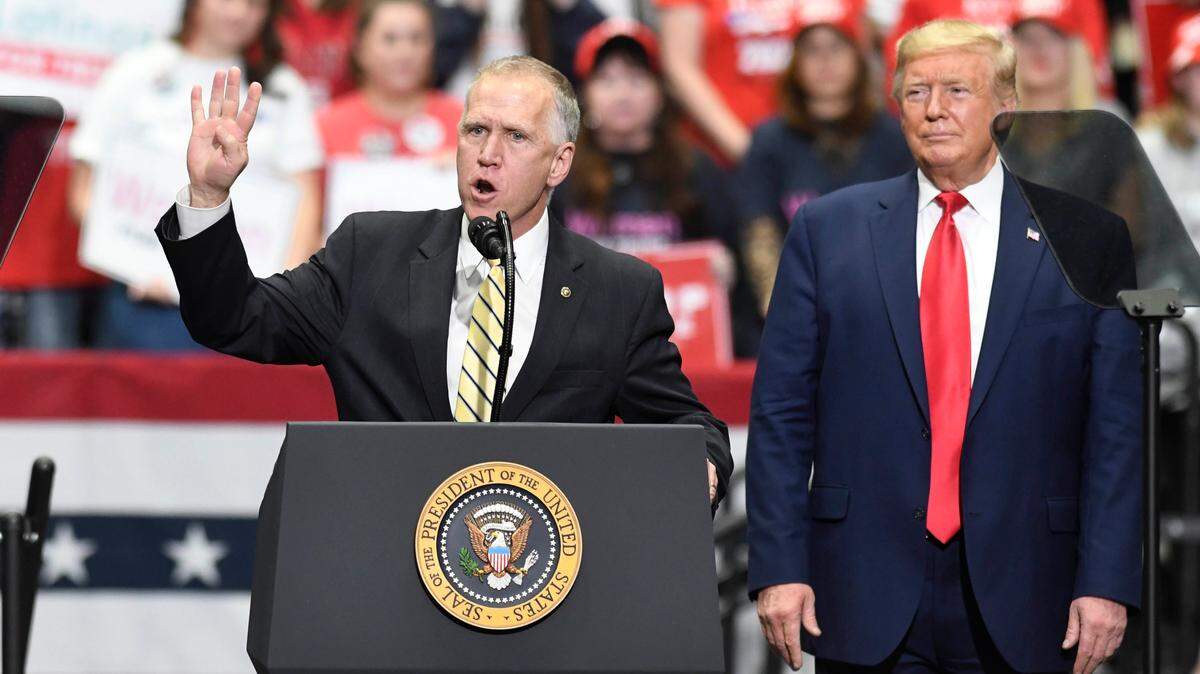 President Donald J. Trump listens as U.S. Senator Thom Tillis of North Carolina addresses supporters during a rally at Bojangles Arena in Charlotte, NC on Monday, March 2, 2020, on the eve of the Super Tuesday primaries.