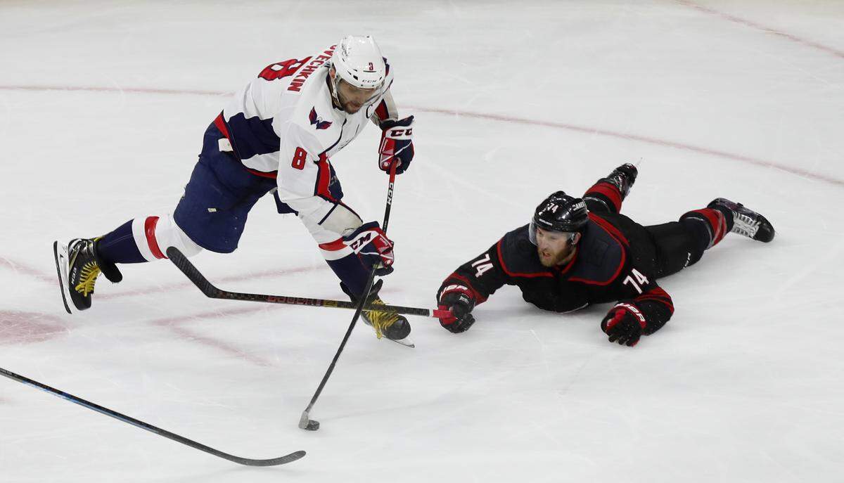 Washington’s Alex Ovechkin (8) shoots and scores as Carolina’s Jaccob Slavin (74) defends during the first period of the Carolina Hurricanes’ game against the Washington Capitals at PNC Arena in Raleigh, N.C., Monday, April 22, 2019.