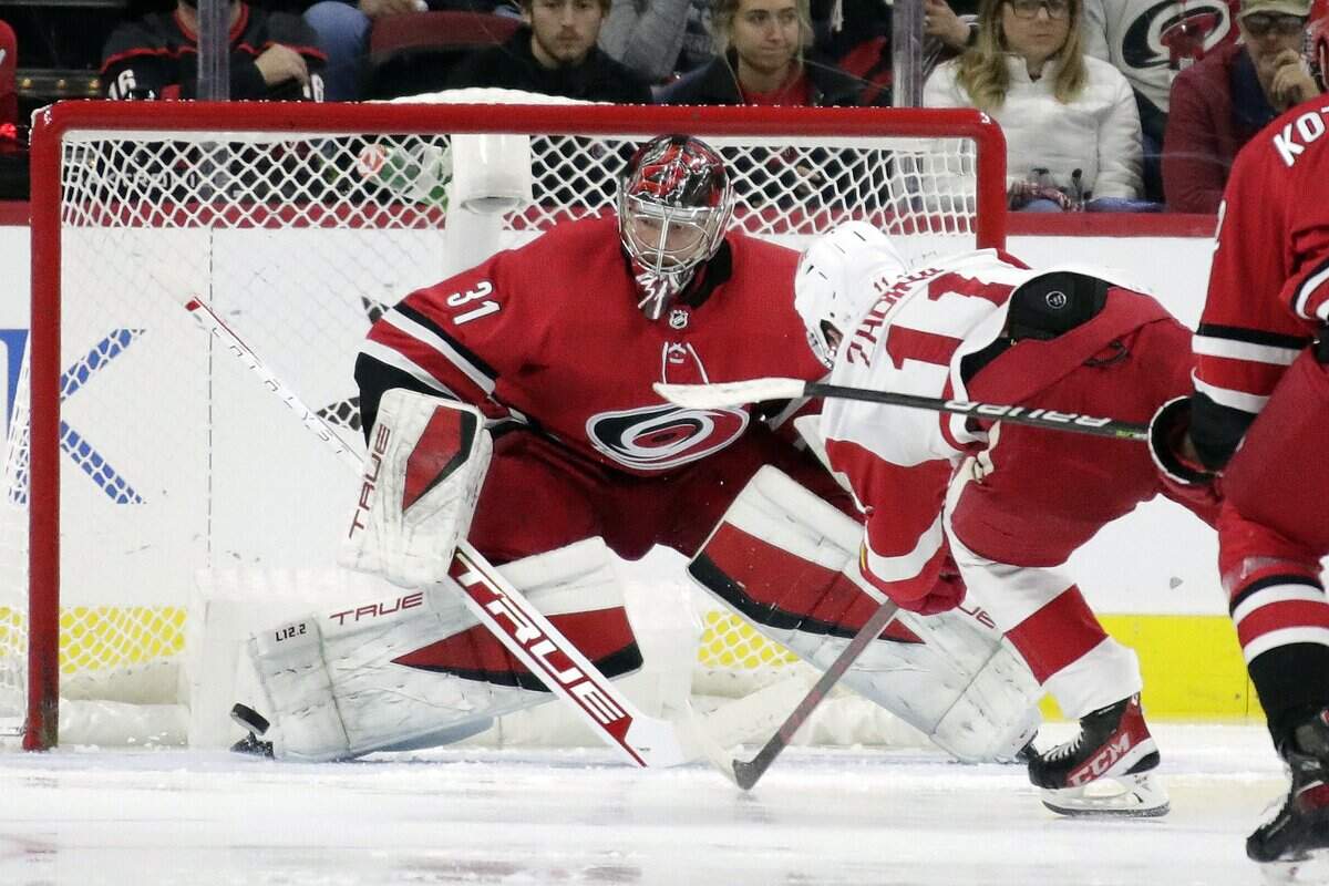 Carolina Hurricanes goaltender Frederik Andersen (31) stops a shot by Detroit Red Wings right wing Filip Zadina (11) during the second period of an NHL hockey game Thursday, Dec. 16, 2021, in Raleigh, N.C. (AP Photo/Chris Seward)