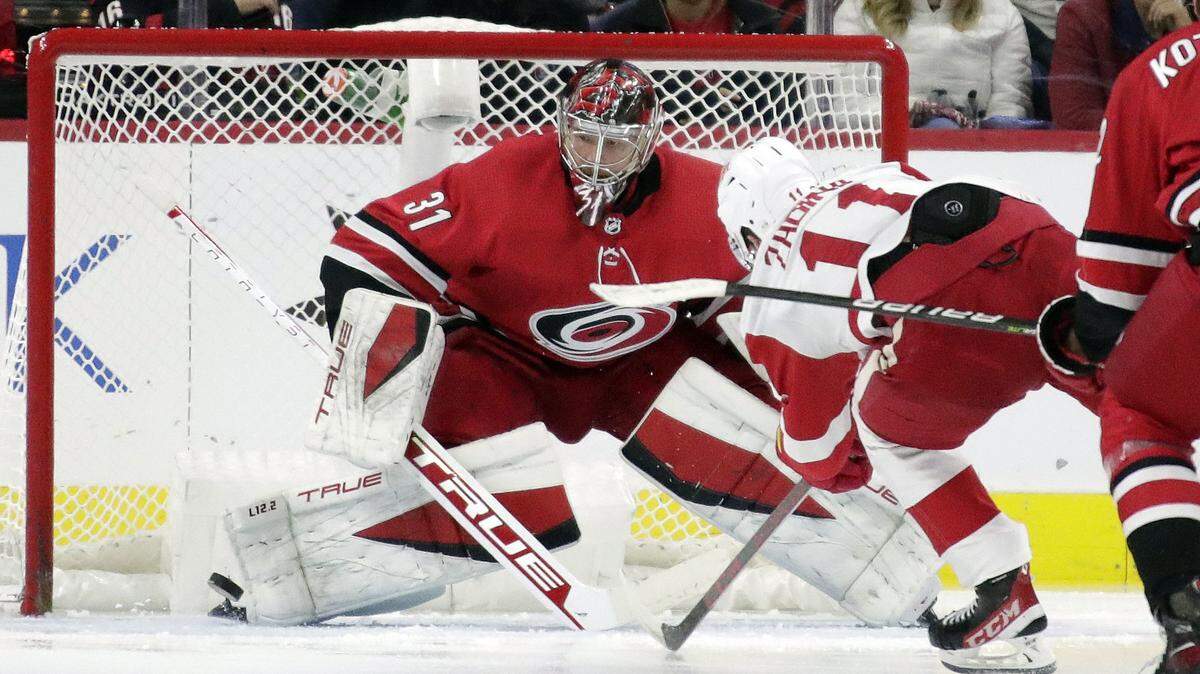 Carolina Hurricanes goaltender Frederik Andersen (31) stops a shot by Detroit Red Wings right wing Filip Zadina (11) during the second period of an NHL hockey game Thursday, Dec. 16, 2021, in Raleigh, N.C. (AP Photo/Chris Seward)