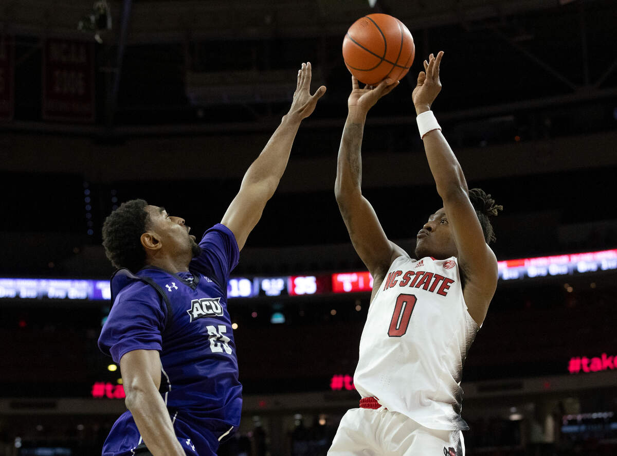 N.C. State’s DJ Horne shoots over Abilene Christian’s Immanuel Allen during the first half of the Wolfpack’s 84-64 win on Friday, Nov. 10, 2023, at PNC Arena in Raleigh, N.C.