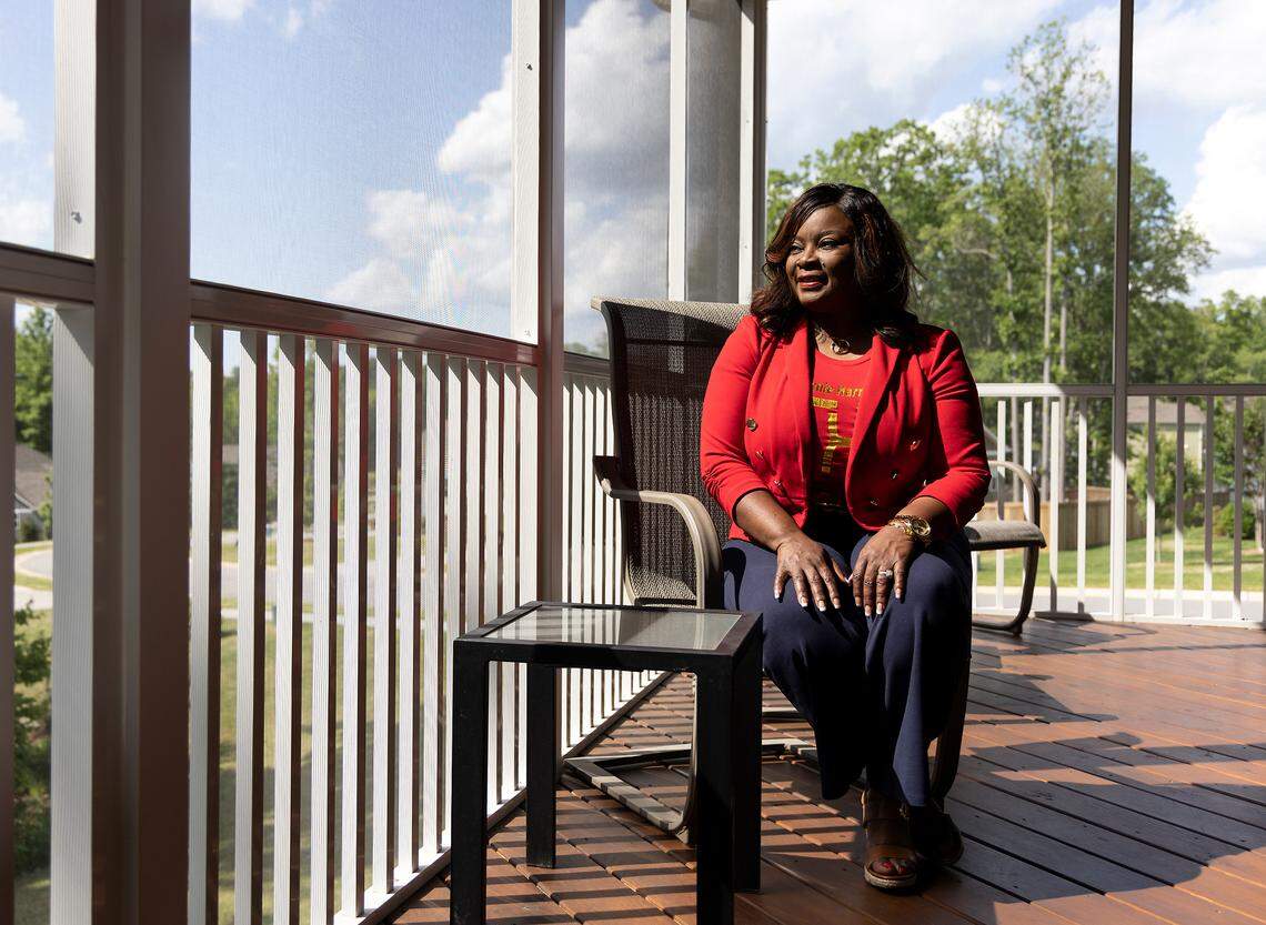 Tammie Harris is photographed on the deck of her home in Durham, N.C. on Tuesday, May 9, 2023. Harris, a real estate broker, recently moved into her seventh home. “I have a passion and an empathy for people who need houses,” said Harris. “Not just a place that they can lay their head, but something that they can leave for legacy and generational wealth.”