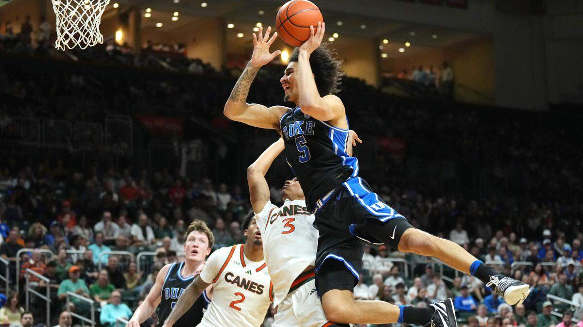 uke Blue Devils guard Tyrese Proctor (5) gets fouled by Miami (Fl) Hurricanes guard Jalil Bethea (3) during the first half at Watsco Center in Miami, Fl., Tuesday, Feb. 25, 2025.
