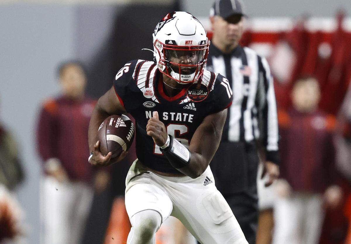 N.C. State quarterback MJ Morris (16) scrambles for yards during the second half of N.C. State’s 22-21 victory over Virginia Tech at Carter-Finley Stadium in Raleigh, N.C., Thursday, Oct. 27, 2022.