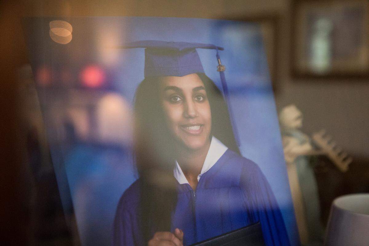 Paige Merical’s graduation portraits sit behind a glass window in her parents’ living room in Wake Forest on Thursday, May 30, 2019. She would be graduating from Wake Forest High School in June. In April, she and her classmate, Ian Lewis, were caught in a rip current while visiting Emerald Isle and neither one survived.
