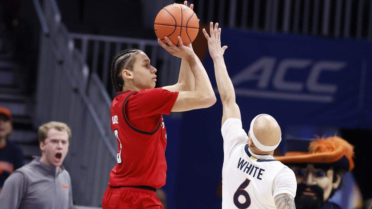 N.C. State's Matt Able (3) shoots as Virginia's Jacari White (6) defends during the first half of N.C. State’s game against Virginia in the quarterfinals of the 2026 ACC Men’s Basketball Tournament at the Spectrum Center in Charlotte, N.C., Thursday, March 12, 2026.
