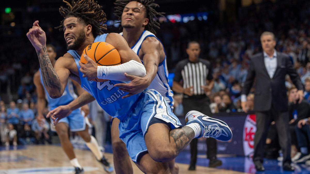 Kentucky’s D.J. Wagner (21) tries to stop North Carolina’s R.J. Davis (4) in the first half on Saturday, December 16, 2023 at State Farm Arena in Atlanta, Georgia.