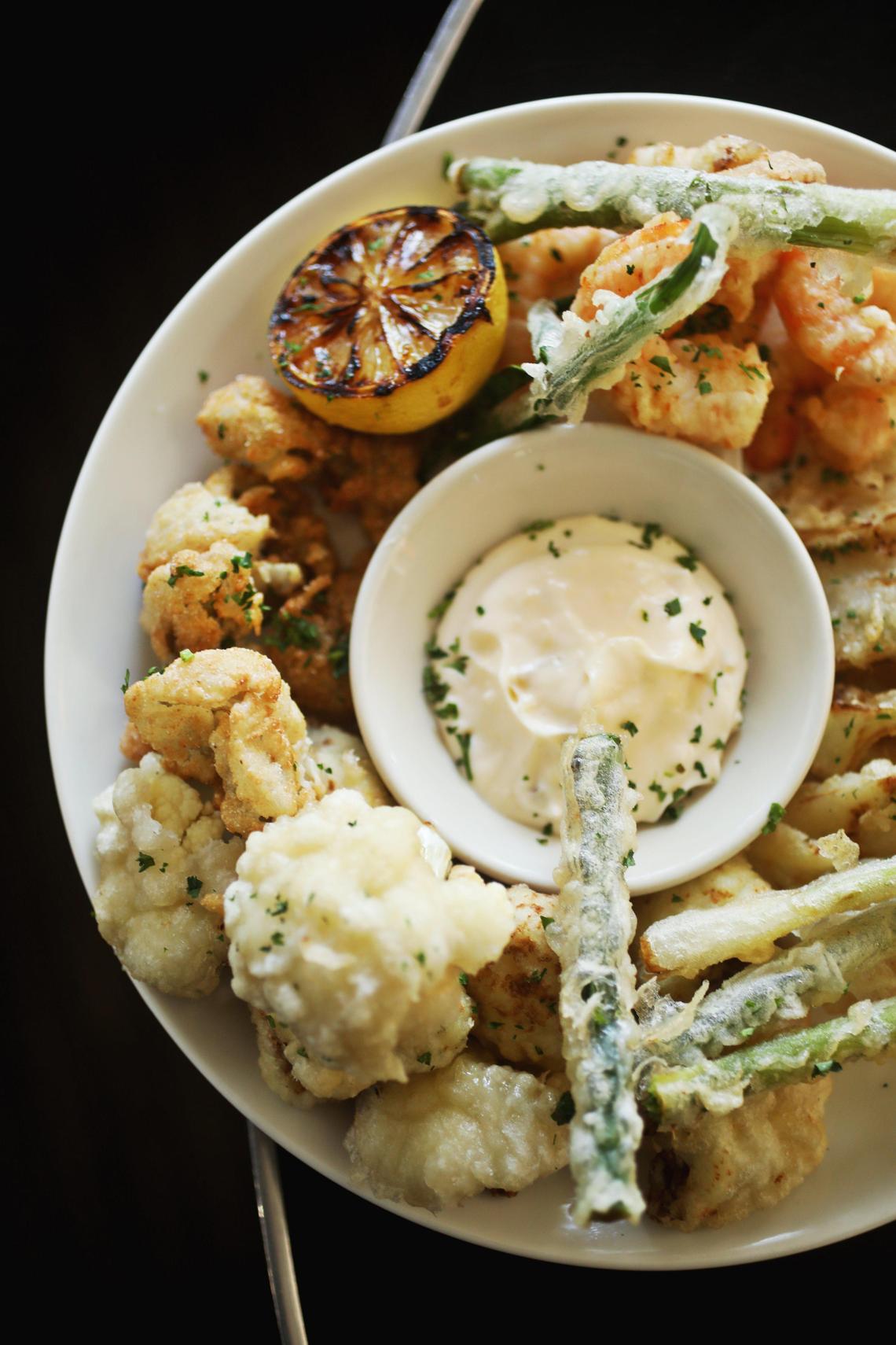 CrookÕs Corner chef Justin Burdett’s shareable starter of fried seafood and vegetables. Shrimp, cauliflower, scallions and fennel are all impeccable in an airy tempura-like batter, while cornmeal breaded oysters are a juicy, delicately crisp reminder that CrookÕs still has some of the best fried oysters around.