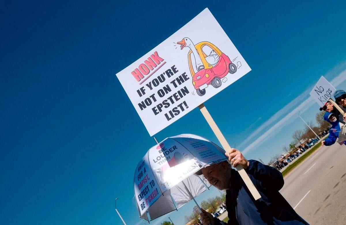 A protesters holds up a sign referencing the Epstein files at the No Kings protest along Raleigh’s Capital Blvd., Saturday, March 28, 2026.