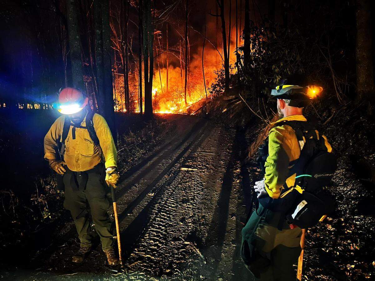 Two firefighters are among a crew of more than 150 who have been struggling to contain the Collett Ridge Fire in the far southwestern corner of North Carolina. Dry, warm weather has helped sustain the blaze.