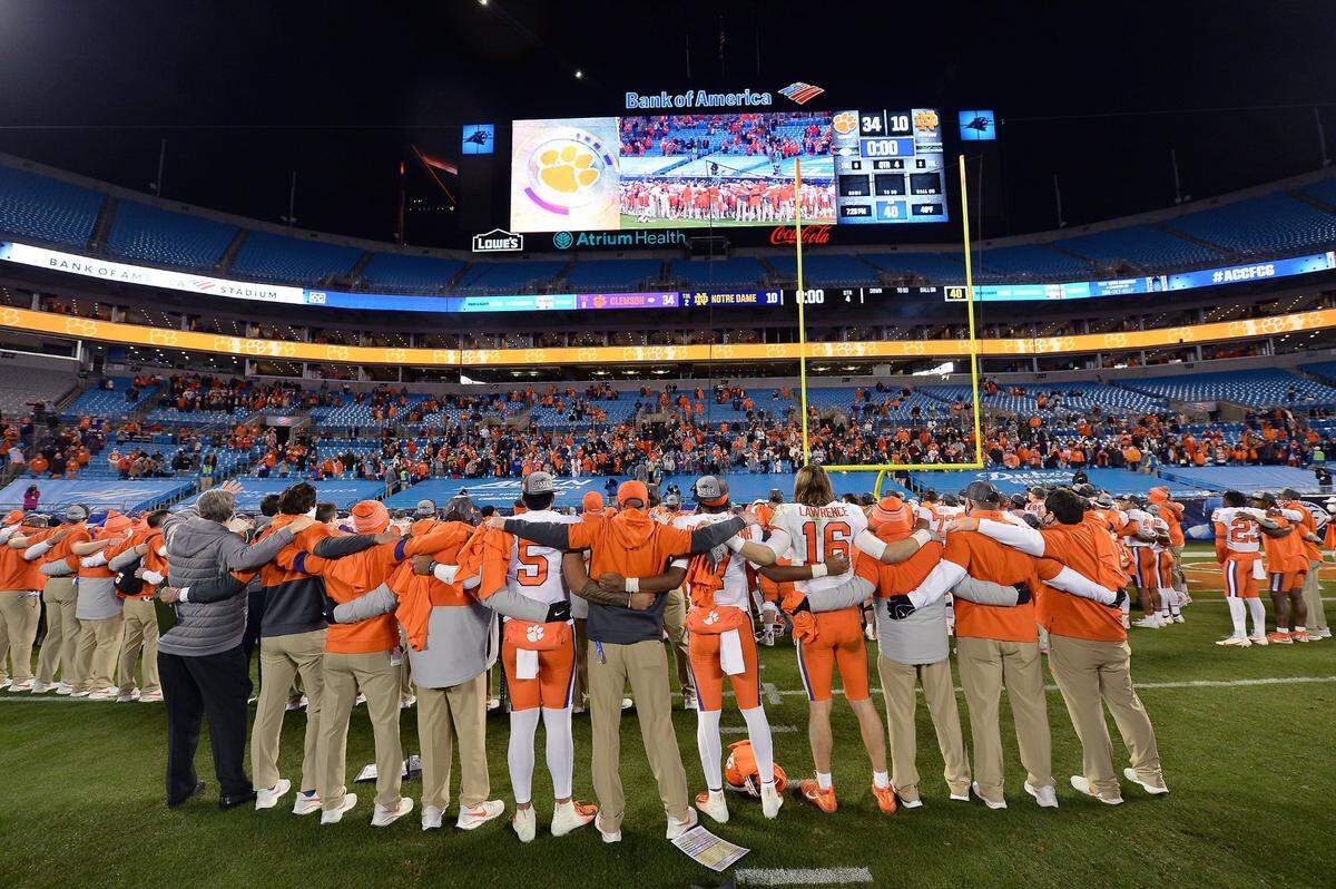 The Clemson Tigers lock arms as they sing the schoolÕs song following their victory in the ACC Championship game. Clemson defeated Notre Dame 34-10 to win the championship at Bank of America Stadium in Charlotte, NC on Saturday, December 19, 2020.