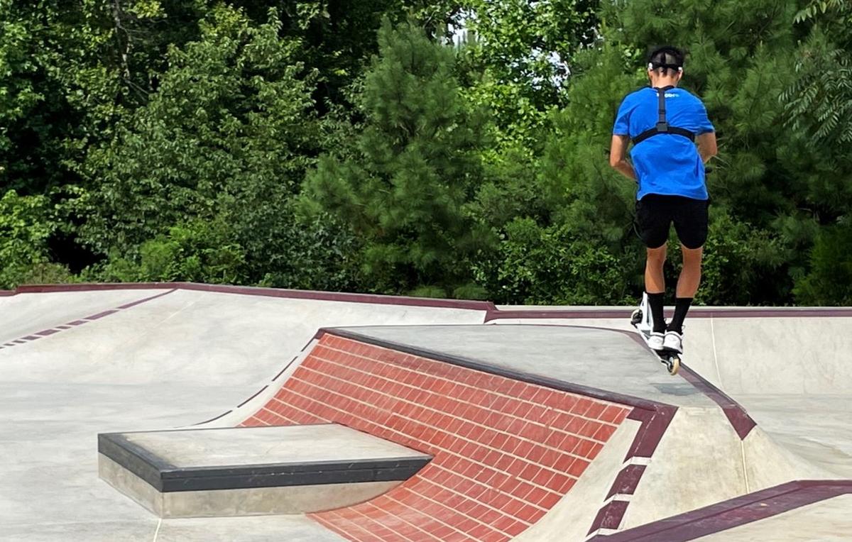 Pro scooter rider Jon Reyes catches a little air while practicing his moves Monday, Aug. 12, 2024, at Hillsborough’s Skate Spot, located off Old N.C. 86 in Hillsborough, N.C. Reyes, who has 1 million followers on YouTube and TikTok, lives in Chapel Hill.
