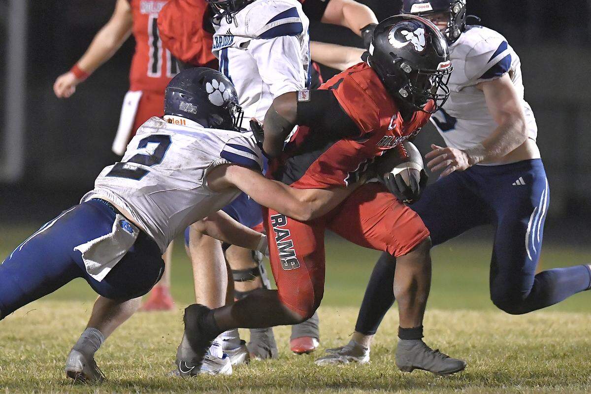 Rolesville running back Amir Brown (0) runs for the first down against Millbrook’s Quinton Cypher (2) during the second half. The Rolesville Rams and the Millbrook Wildcats met in a football game in Raleigh. N.C. on October 11, 2024. 