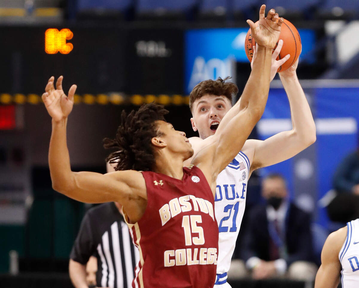 Duke’s Matthew Hurt (21) pulls in the rebound from Boston College’s DeMarr Langford Jr. (15) during the first half of Duke’s game against Boston College in the first round of the ACC Men’s Basketball Tournament in Greensboro, N.C., Tuesday, March 9, 2021.