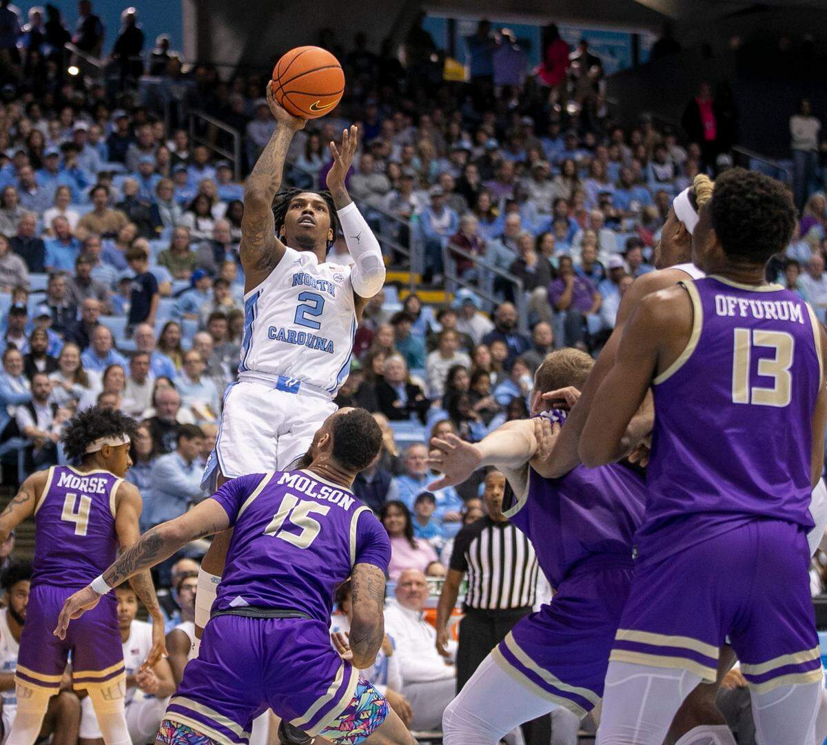 North Carolina’s Caleb Love (2) puts up a shot against James Madison’s Takal Molson (15) in the second half on Sunday, November 20, 2022 at the Smith Center in Chapel Hill, N.C.