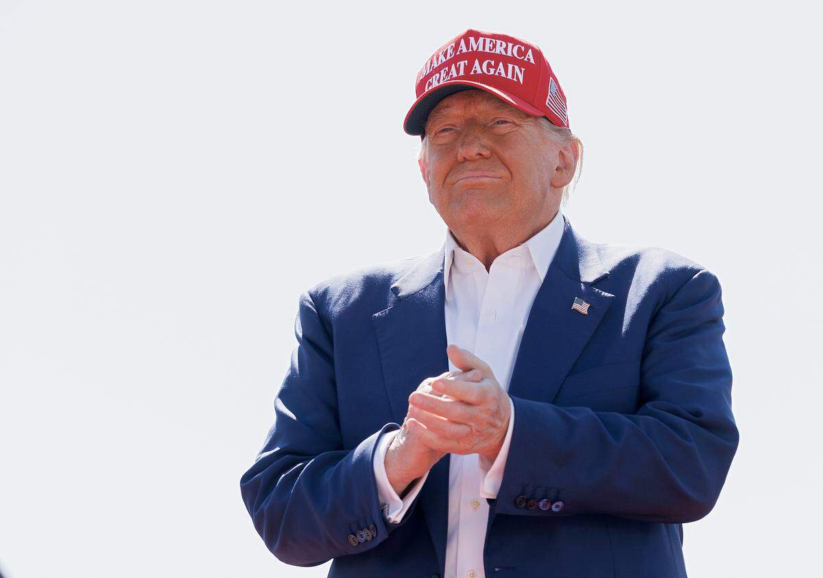Former President and current Republican candidate for president Donald Trump smiles at the crowd after arriving to a rally in Wilmington, N.C. on Saturday, Sept. 21, 2024.