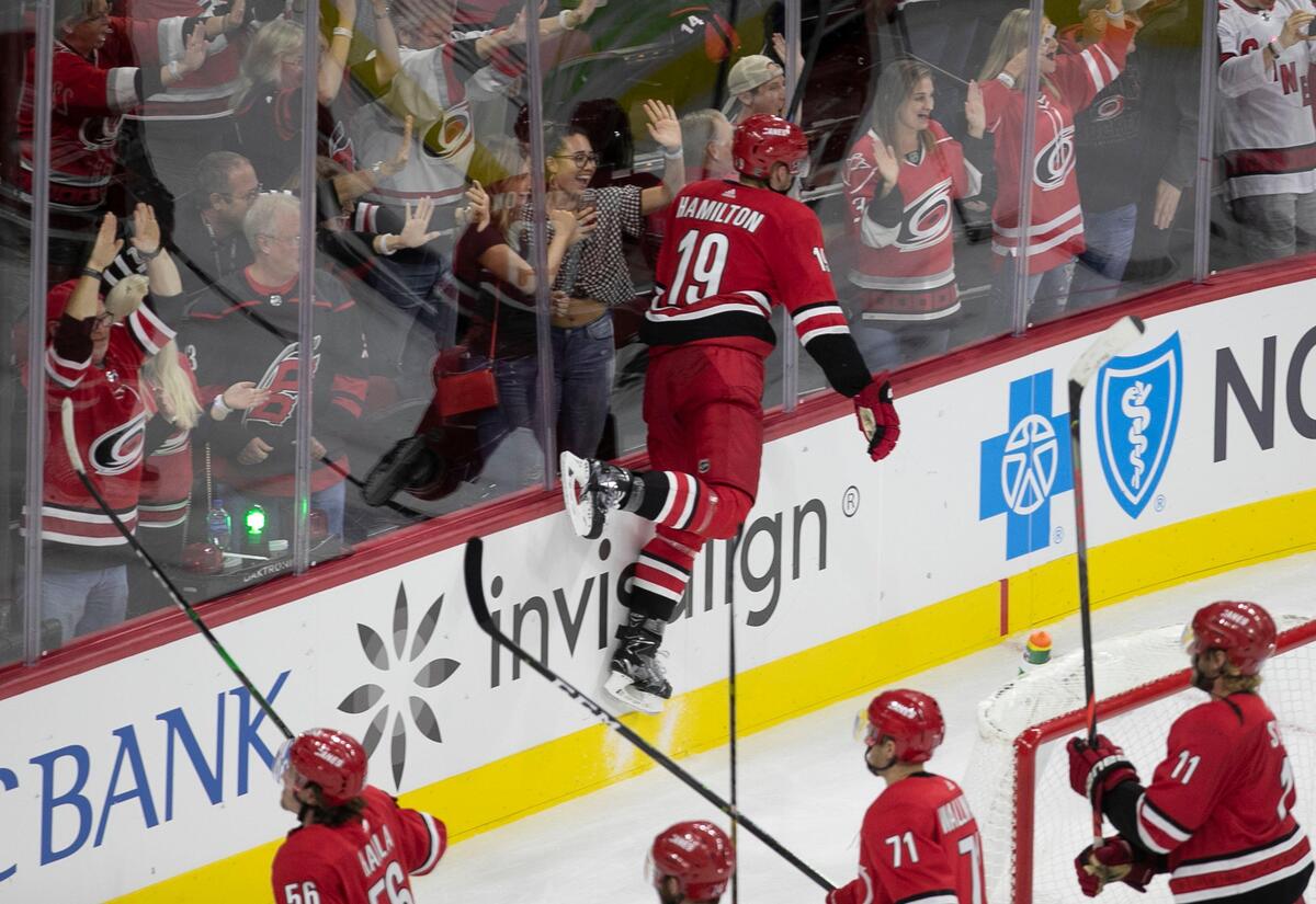 Carolina Hurricanes’ Dougie Hamilton (19) crashes the boards in celebration after defeating the Montreal Canadiens 4-3 in a shootout on Thursday, October 3, 2019 at the PNC Arena in Raleigh, N.C.