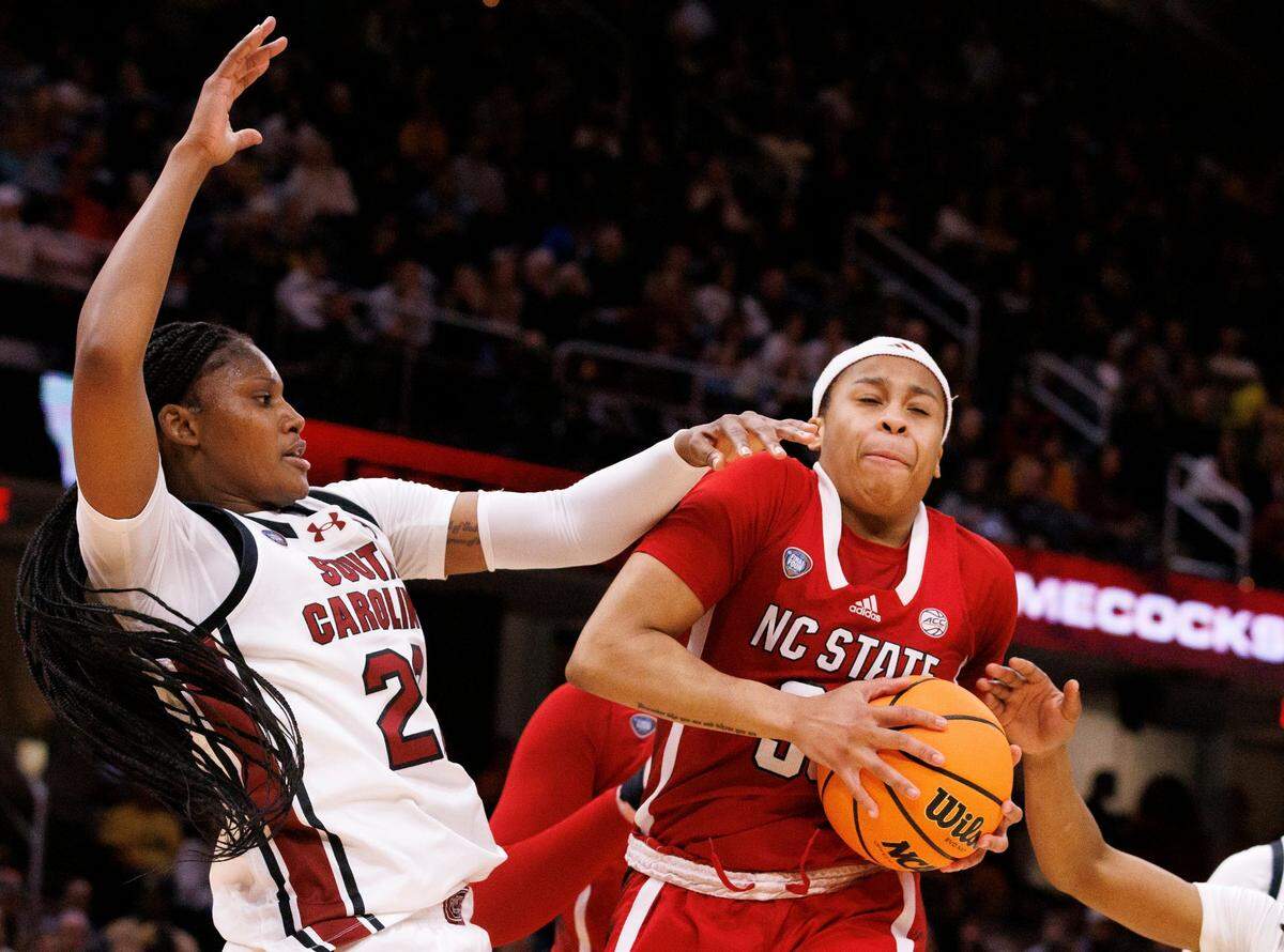 N.C. State’s Zoe Brooks pulls down a rebound away from South Carolina’s Sania Feagin during the second half of the Wolfpack’s 78-59 Final Four loss to South Carolina at Rocket Mortgage FieldHouse on Friday, April 5, 2024, in Cleveland, Ohio.