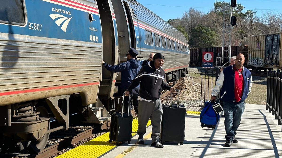 Passengers disembark from an Amtrak train.