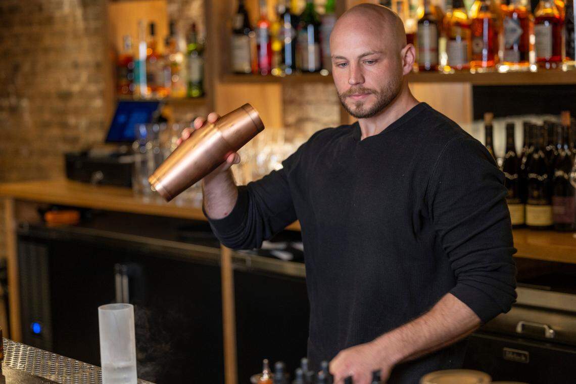 Beverage director Jordan Joseph mixes a drink at Scott Crawford’s new cocktail bar, Sous Terre, at 620 North Person Street below Jolie, Crawford’s French bistro.