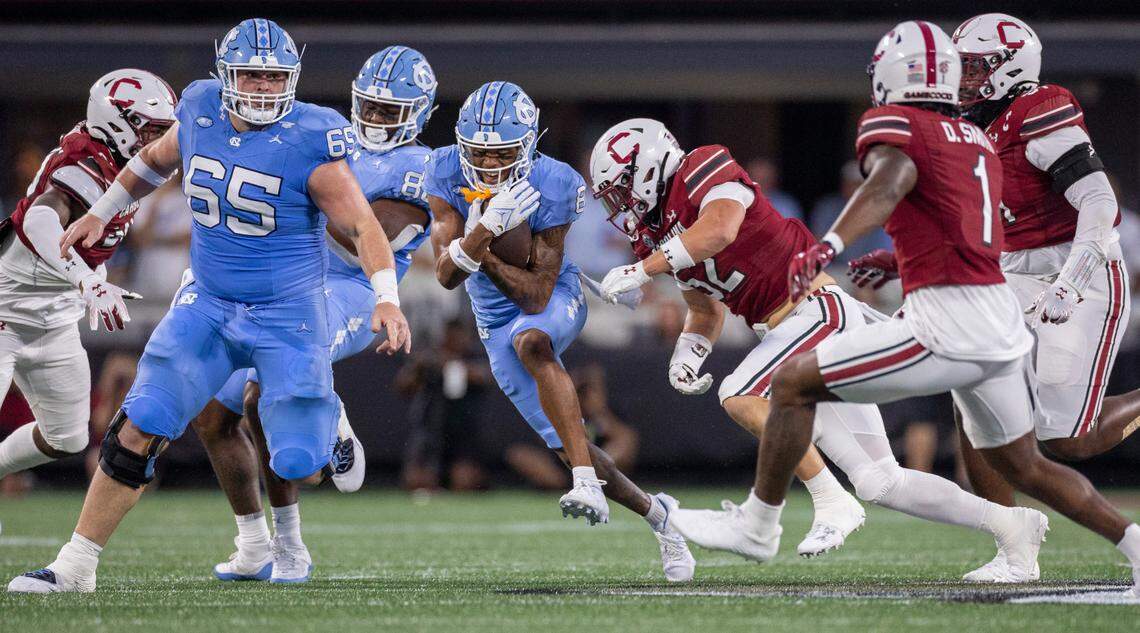 North Carolina’s Kobe Paysour (8) picks up eight yards after a pass completion from quarterback Drake Maye in the first quarter against South Carolina on Saturday September 2, 2023 at Bank of America Stadium in Charlotte, N.C.